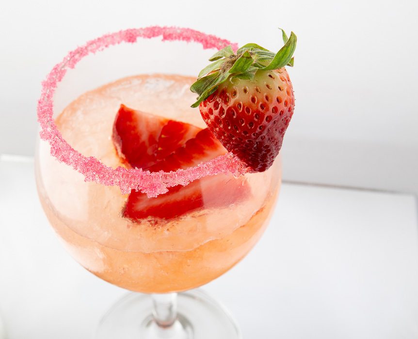 Closer view of a well presented drink with the glass decorated with a strawberry